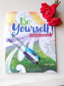 photo of Be Yourself journal for girls with a flower and pens on it