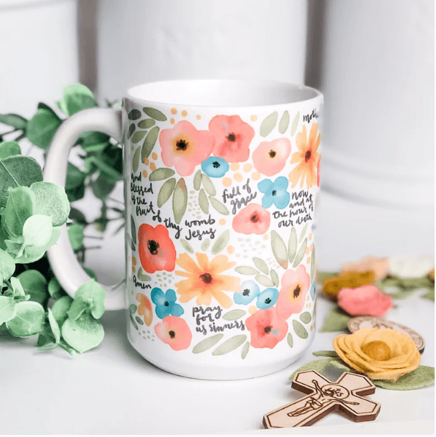 Mug with flowers and the Hail Mary written on it