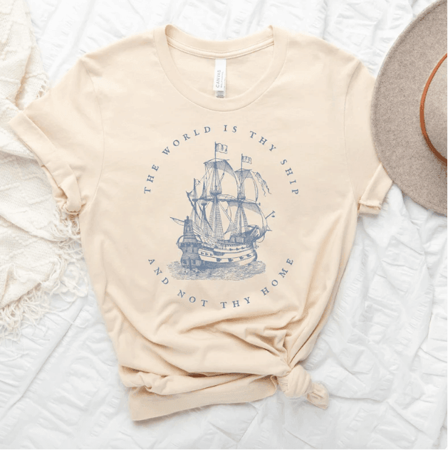 Tee shirt with a ship on it and the quote around the ship says THE WORLD IS THY SHIP NOT THY HOME