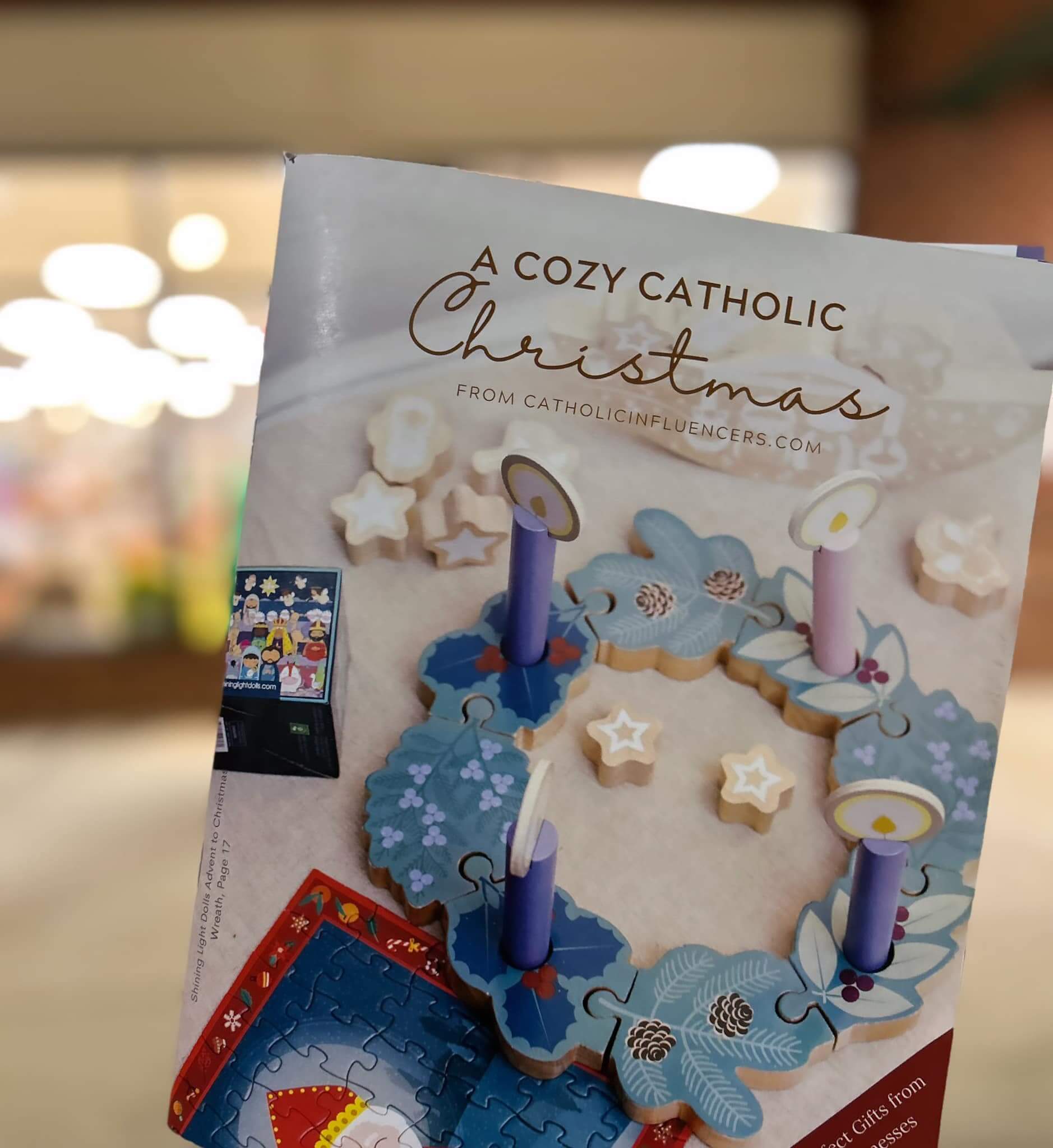 picture of A Cozy Catholic Christmas Catalog in front of Hallmark store