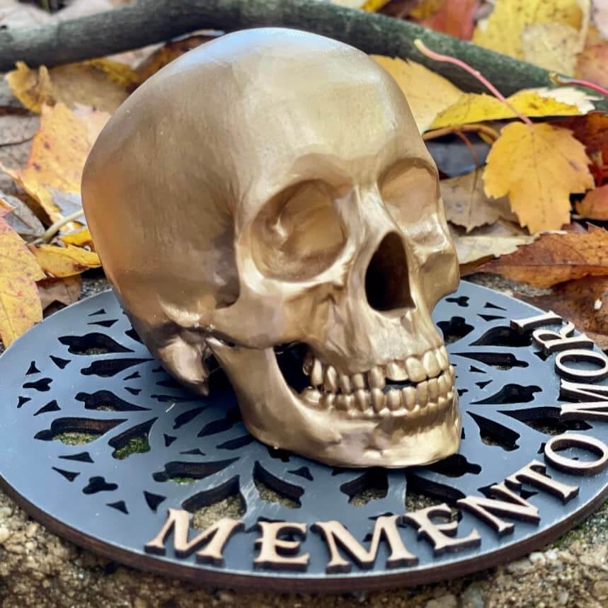 Ginny and Sage Catholic decor skull on base that says Membento Mori